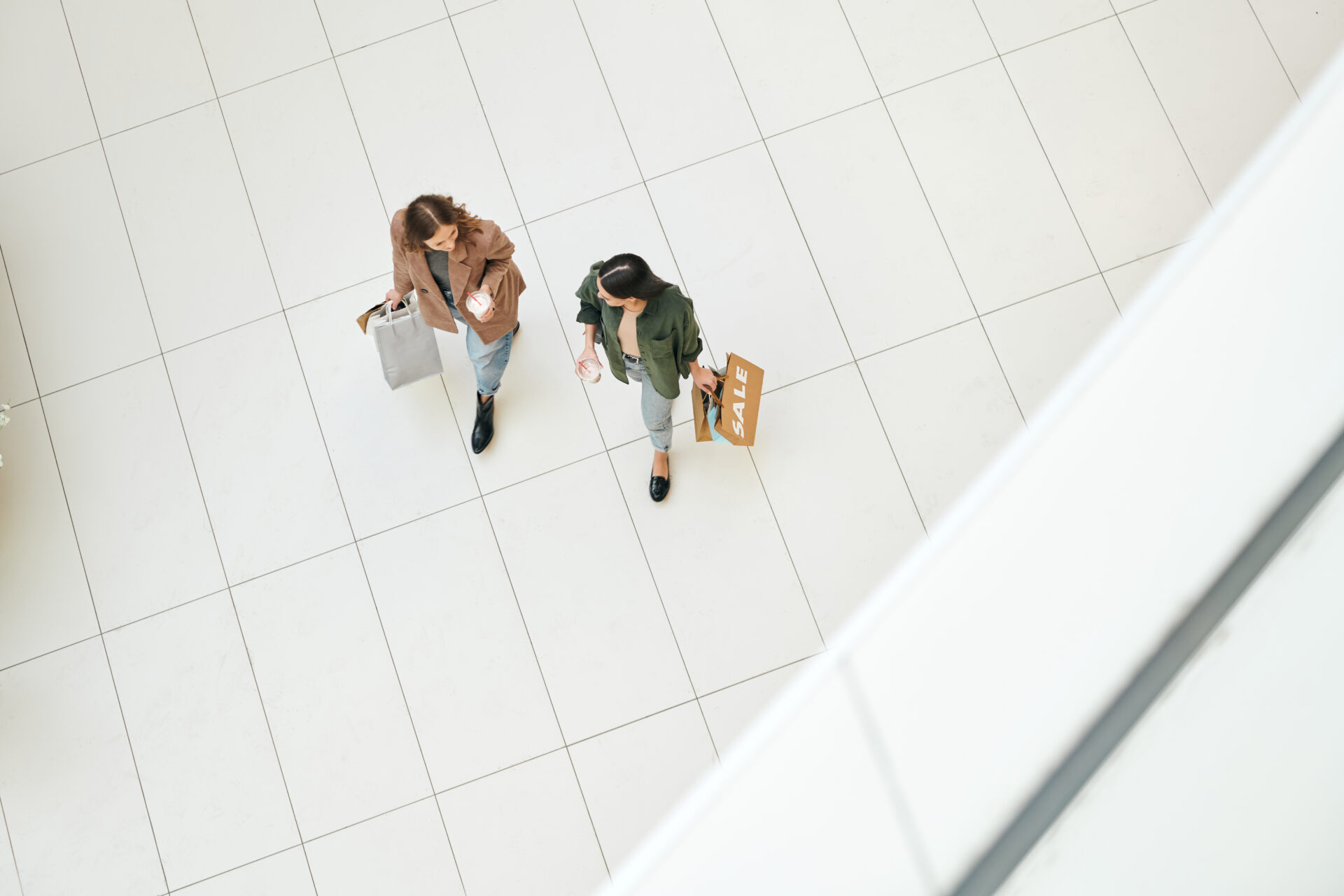 young-female-consumers-walking-in-retail-mall